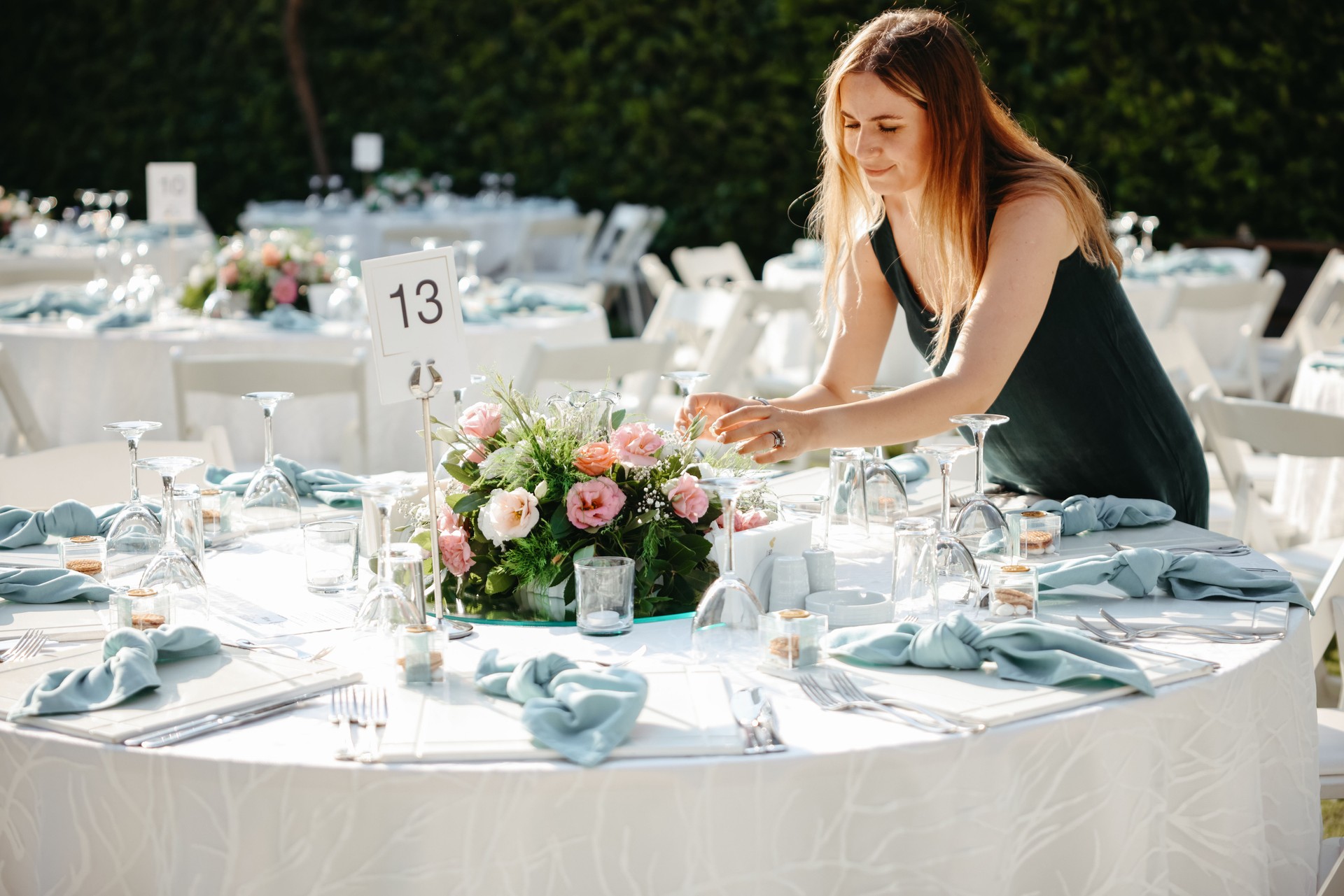 Young woman making fresh flowers wedding decoration